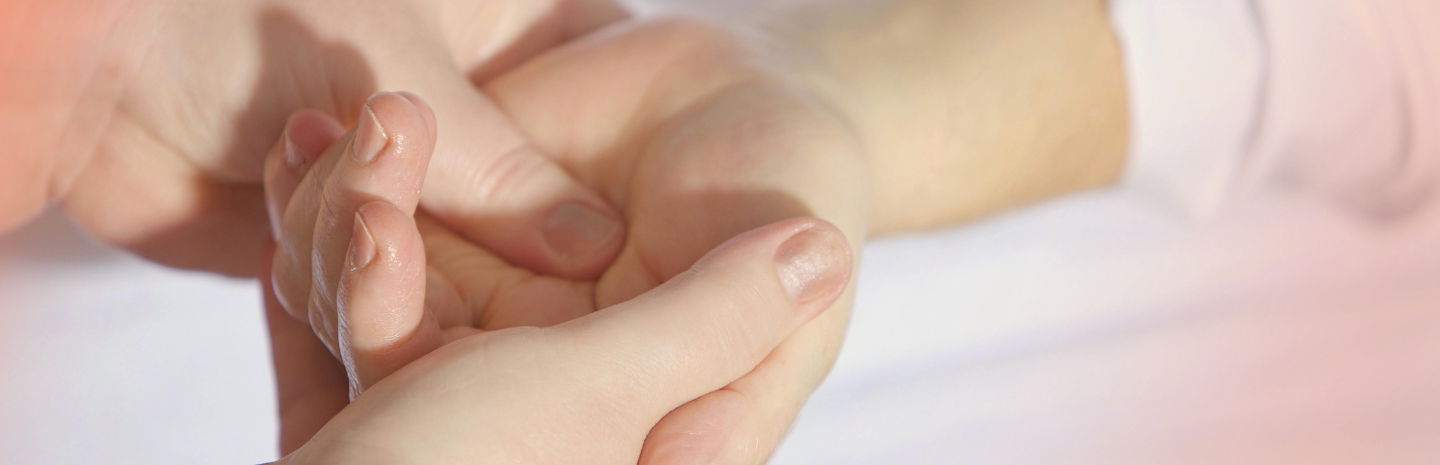 Two hands gently clasping each other, displaying a moment of tenderness and connection. Soft lighting enhances the intimate scene.
