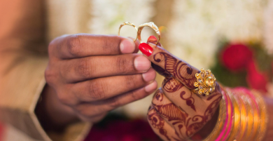Close-up of hands holding a ring with blurred background