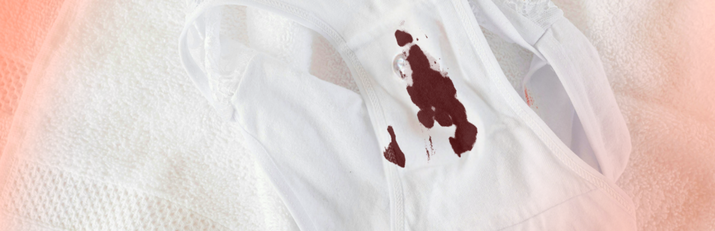 White underwear with a noticeable brown period blood stain on the crotch area