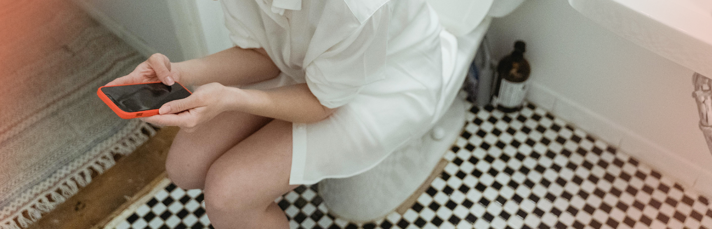 Woman experiencing diarrhoea during period, a common PMS symptom